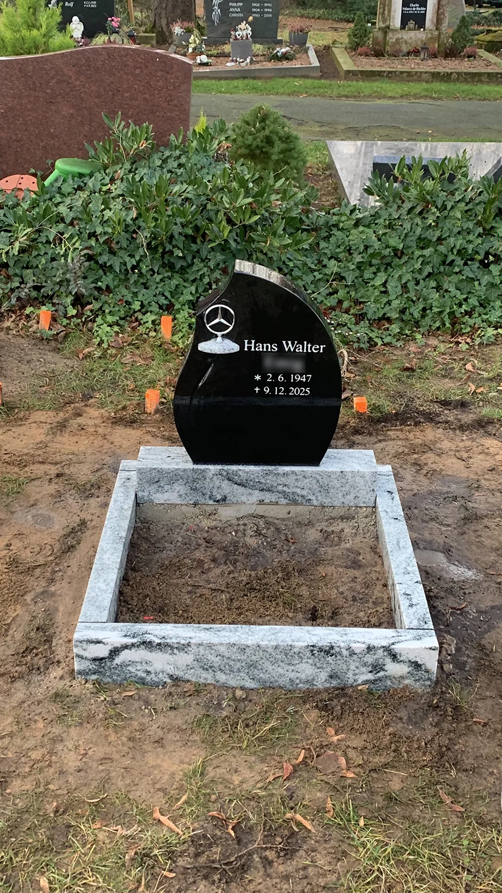 Schwarzer Grabstein mit Mercedes Stern